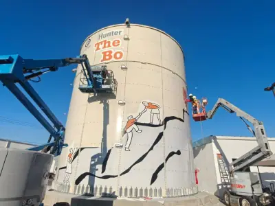 Tank graphics installed at height with two boom lifts